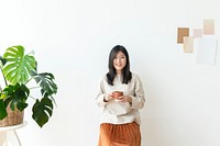 Asian woman with a cup of coffee in her hand