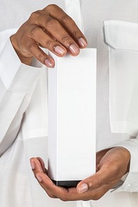 Hands holding a white blank cosmetic packaging