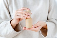 Woman holding a skin foundation bottle
