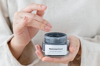 Woman holding a face cream jar mockup