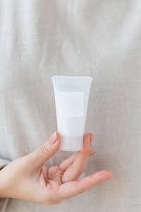 Woman holding  a facial cream tube