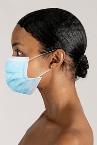 Black woman wearing a surgical mask in a profile shot