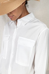 Woman in a white shirt and a woven hat