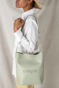 Black woman carrying a sage green shoulder bag mockup