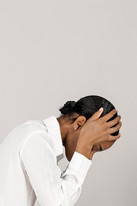 Unhappy black woman touching her head