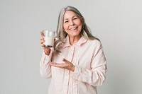 Cheerful senior woman drinking a glass of milk