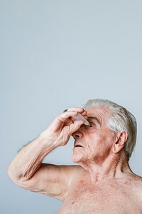 Senior man applying eye drops