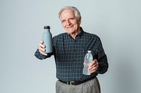 Happy senior man holding a reusable and a plastic water bottle