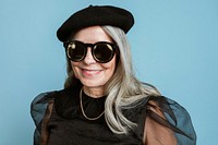 Beautiful senior woman in a cool beret and sunglasses