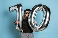 Cool grandma celebrating her 70th birthday with balloons