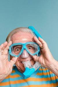 Cheerful senior man wearing a snorkel and scuba mask