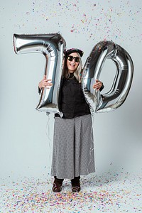 Cool grandma celebrating her 70th birthday with balloons