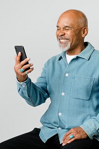 Happy retired man using a smartphone