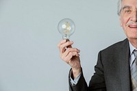 Happy senior businessman with a light bulb