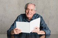 Happy senior man reading a book