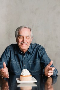 Senior man with a cupcake