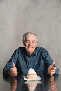 Senior man with a cupcake