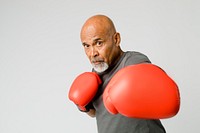 Senior man with red boxing gloves