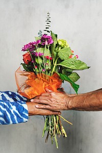 Husband surprising his wife with a bouquet of flowers 