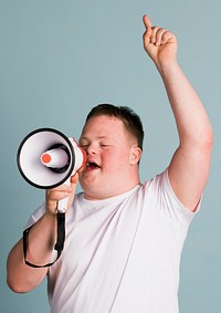 Cute boy with down syndrome using a megaphone to amplify his voice  