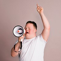 Cute boy with down syndrome using a megaphone to amplify his voice  