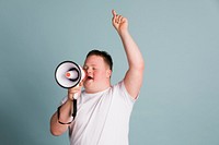 Cute boy with down syndrome using a megaphone to amplify his voice  