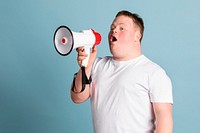 Cute boy with down syndrome using a megaphone to amplify his voice  