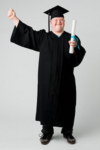 Happy boy with down syndrome in a graduation gown