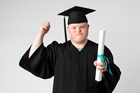 Proud boy with down syndrome in a graduation gown