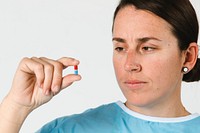 Patient holding a red and blue pill