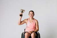 Athlete in a wheelchair holding a trophy 