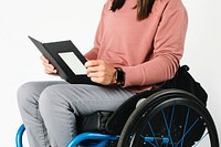 Cool woman in a wheelchair reading a book