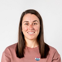 Cheerful woman with a vote sticker on her sweater