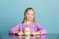 Cute girl with Down Syndrome celebrating a birthday