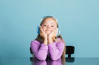 Cute little girl with Down Syndrome listening to music