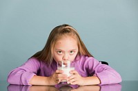 Cute girl with down syndrome drinking milk