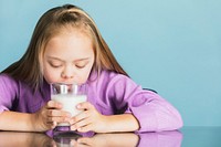 Cute girl with down syndrome drinking milk