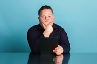 Confident boy with down syndrome homeschooling using a digital tablet during the coronavirus pandemic