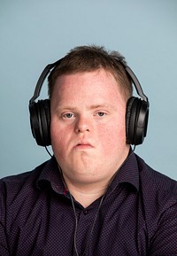 Young man with Down syndrome listening to some news
