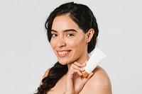 Beautiful woman holding a skin care product