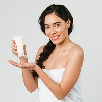 Beautiful woman holding a skin care product