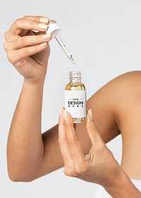 Young woman using a bottle dropper mockup 