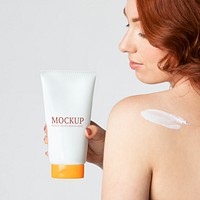 Woman holding a skin care product mockup