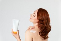 Beautiful woman holding a skin care product