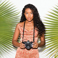 Beautiful black woman with an analog camera