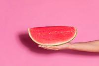 Woman holding a juicy slice of watermelon 