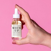 Woman holding a bottle dropper mockup 