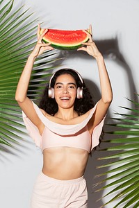 Happy woman holding a slice of watermelon 