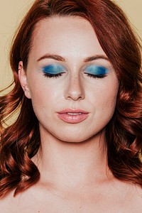 Red headed woman wearing 80s makeup 