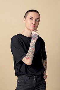 Thoughtful model with tattoos in black T shirt